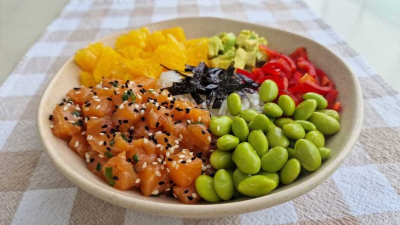 Salmon Poke Bowl recipe with edamame, pepper, orange, avocado