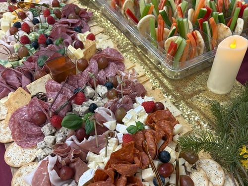 Elaborate charcuterie board with assorted meats, cheeses, fruits, and crackers.