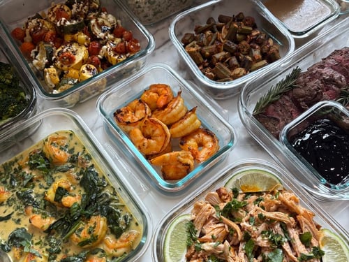 Close-up of shredded chicken with lime wedges and salsa.