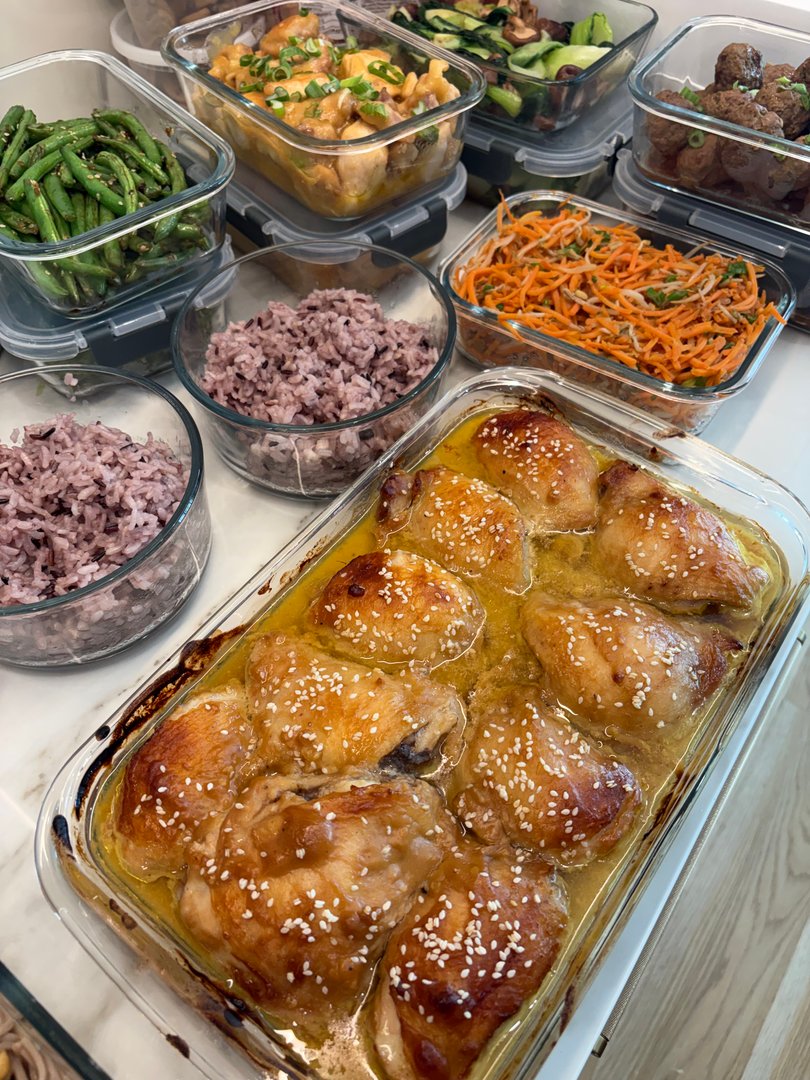 Baked chicken thighs, purple rice, green beans, and other Asian meal prep.