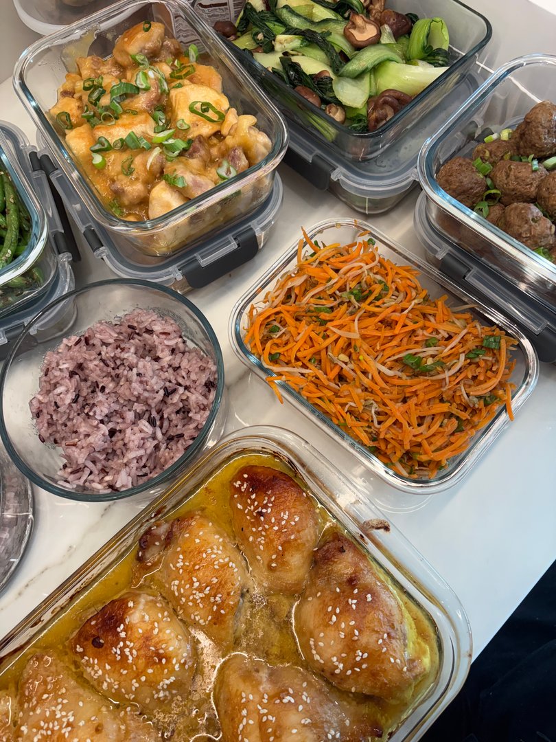 Overhead shot of Pan-Asian meal prep with chicken, rice, and shredded carrots.