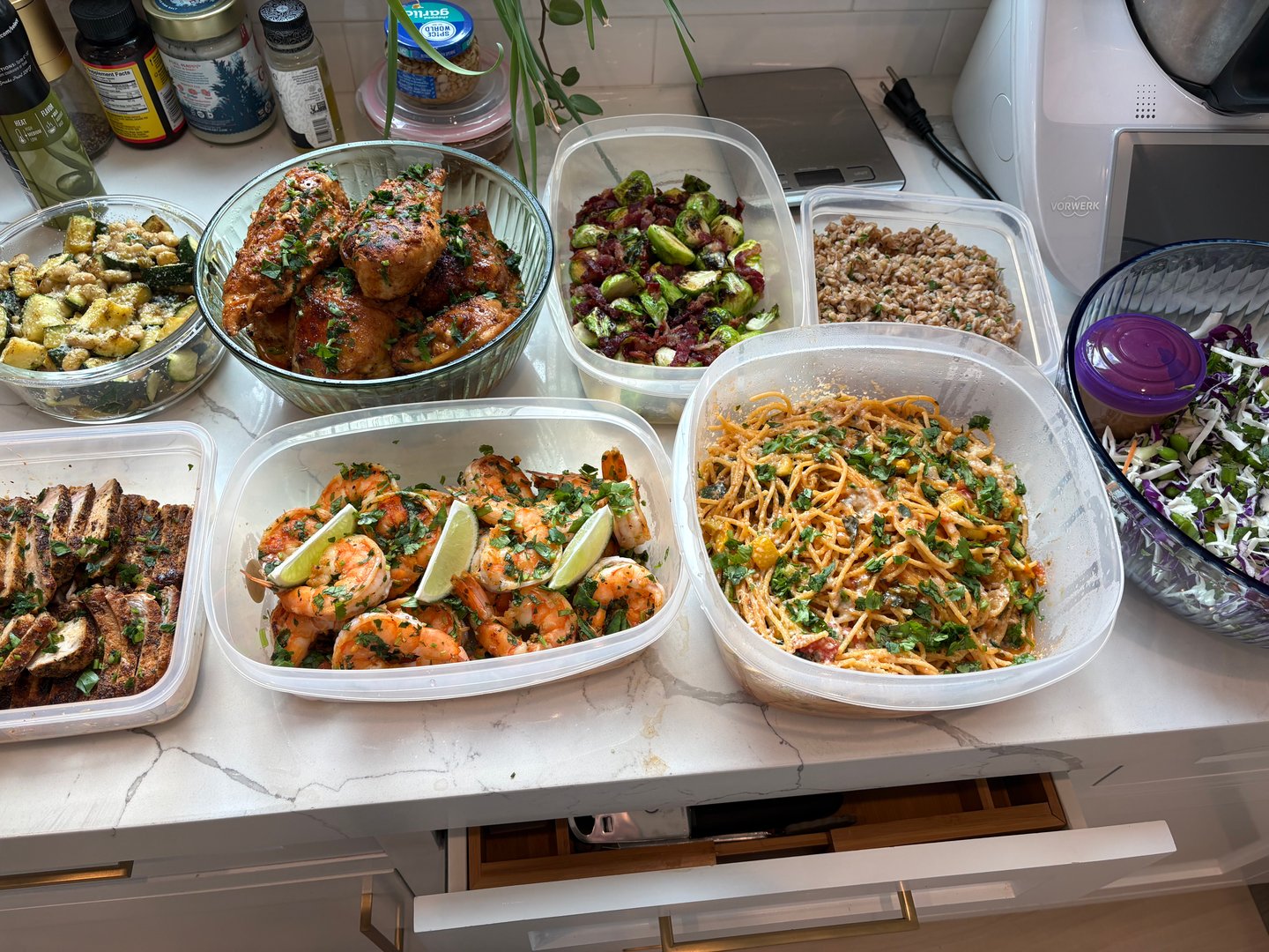 Full spread of gourmet meal prep containers on a kitchen counter.