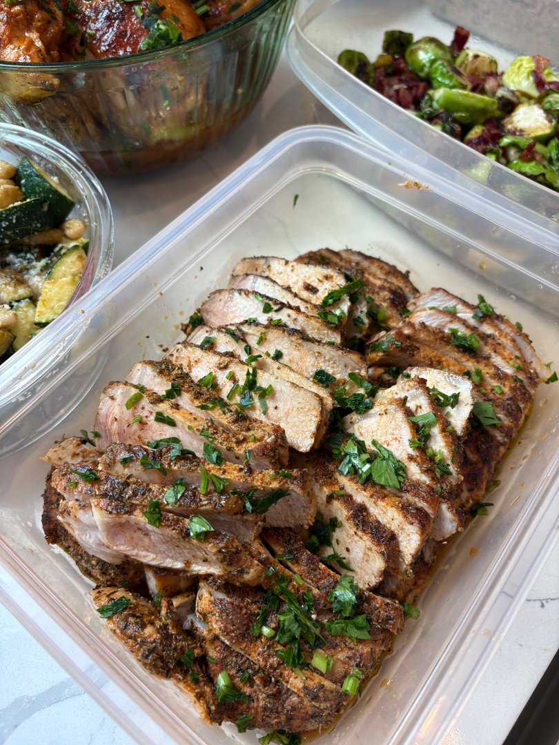 Slices of seasoned pork loin garnished with fresh cilantro.