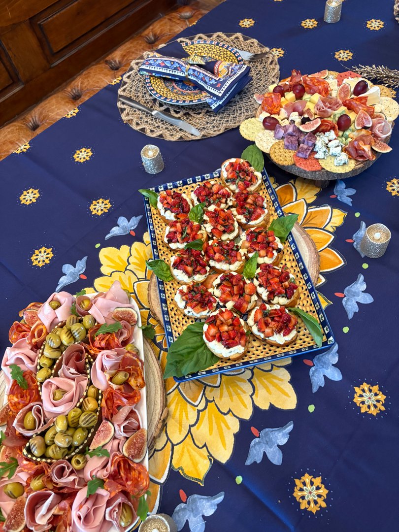 Full table spread with charcuterie boards and strawberry bruschetta.