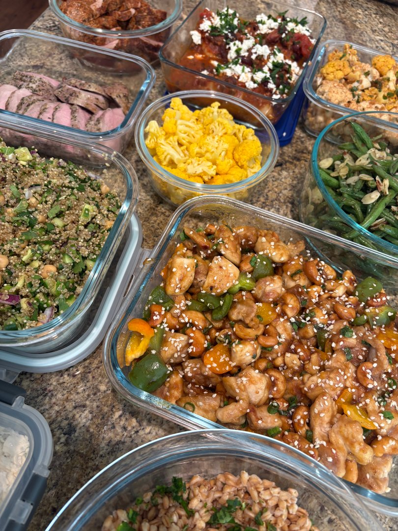 Close-up of cashew chicken, quinoa salad, and roasted vegetables