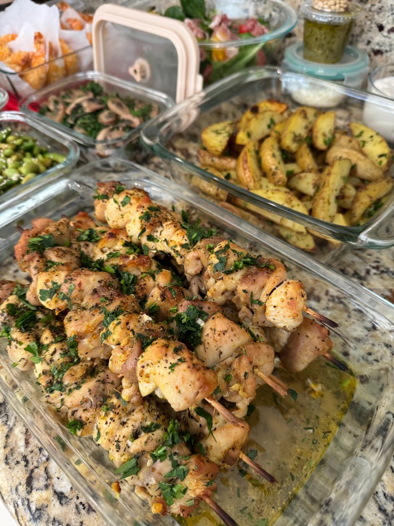 Herb-marinated chicken skewers with roasted potato wedges.