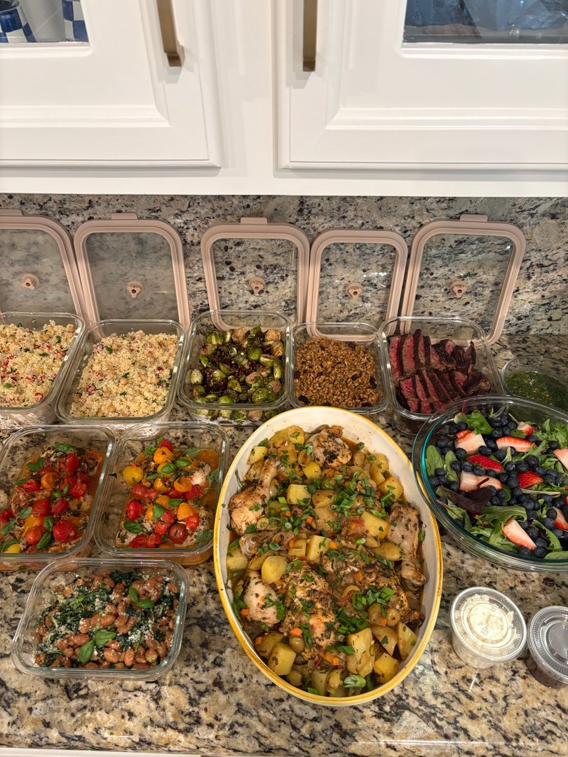 Full spread of weekly meal prep containers and large serving dishes.