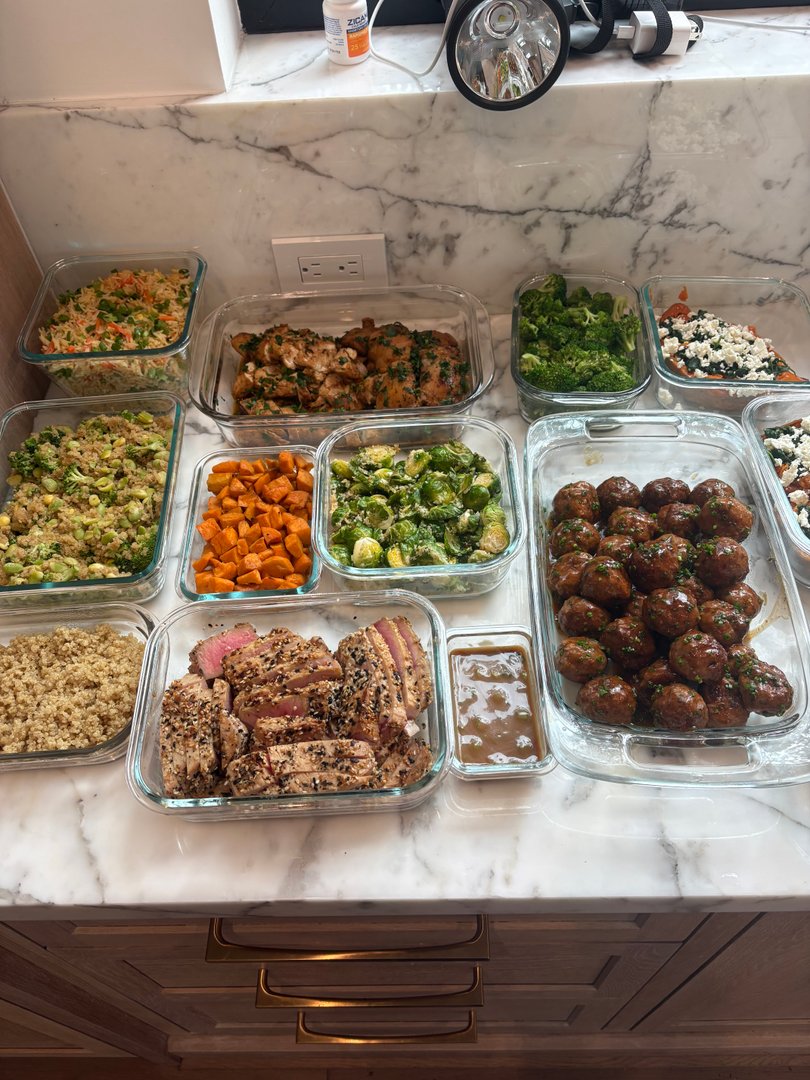 Full spread of meal prep containers on a kitchen counter.
