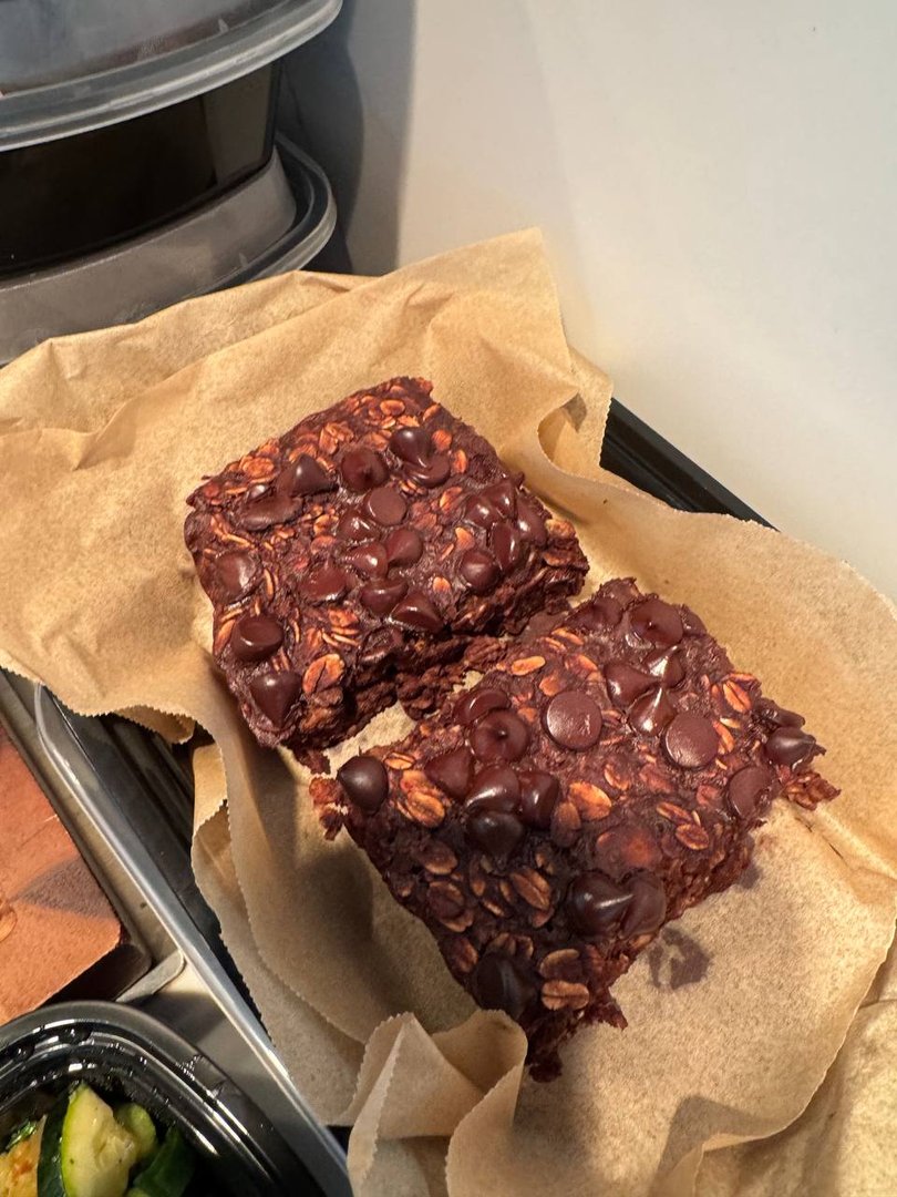 Two chocolate chip oat bars on brown parchment paper