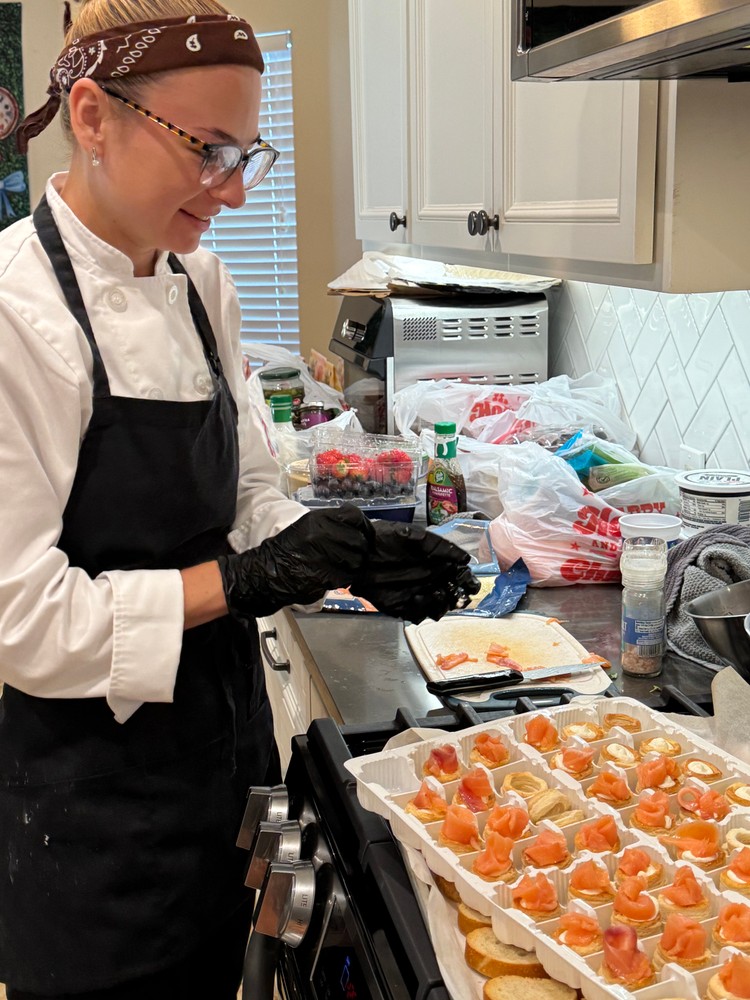 Chef Ana preparing appetizers with a smile.