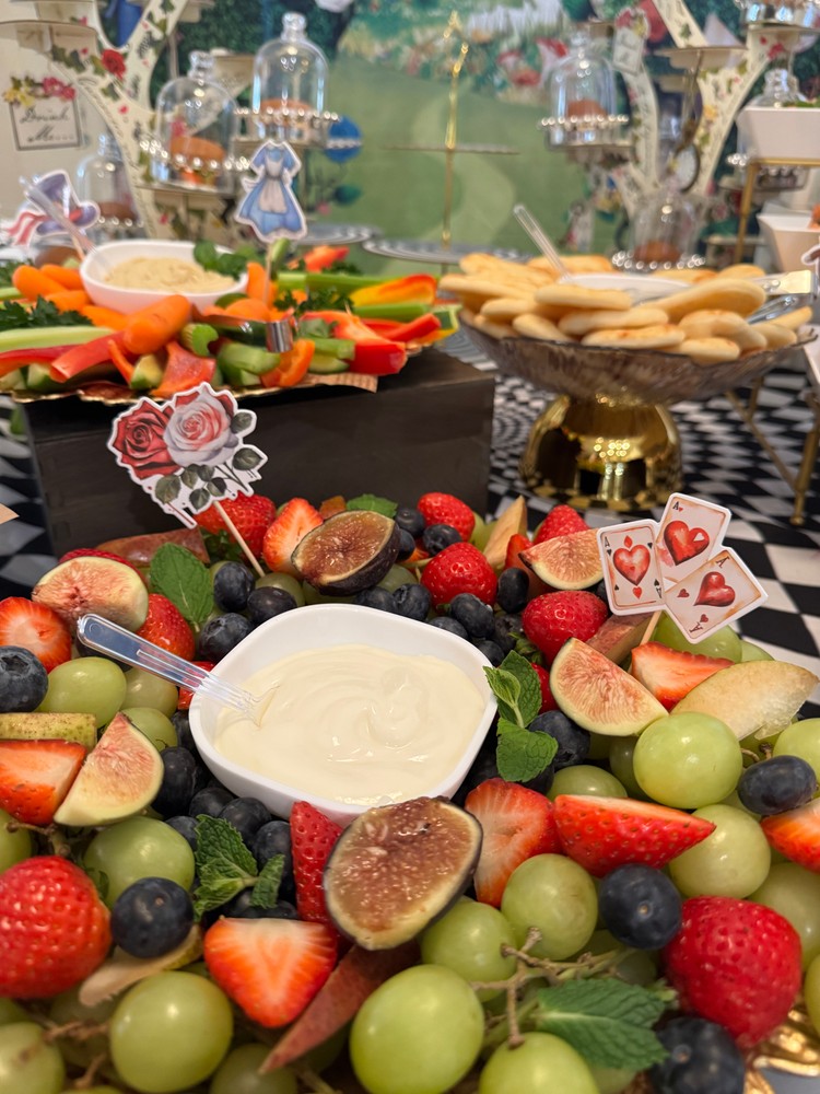 Fresh fruit platter with berries, figs, and cream cheese dip.