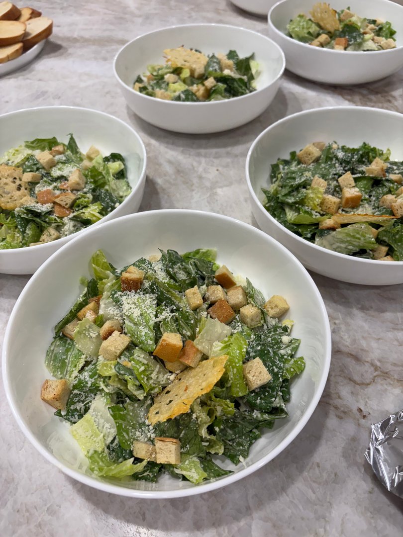 Individual servings of Caesar salad with croutons and Parmesan cheese.