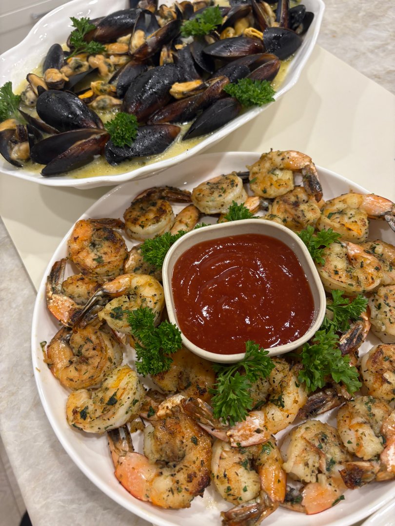 Garlic seared shrimp with cocktail sauce and fresh parsley.